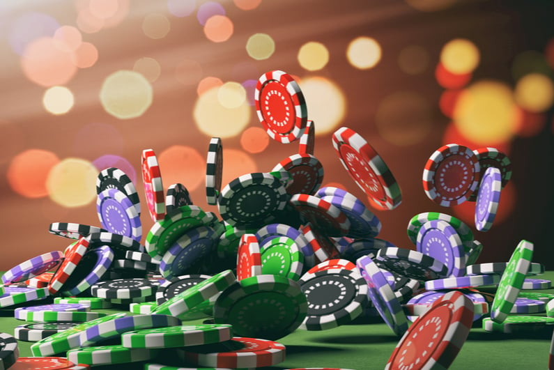 Casino poker chips falling on green felt background. 3d illustration