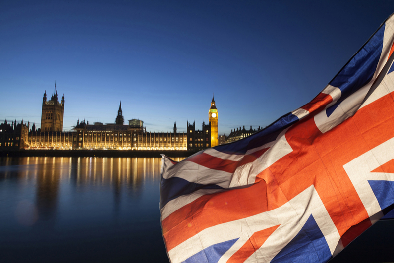 Union jack flag and Big Ben in the background, London, UK