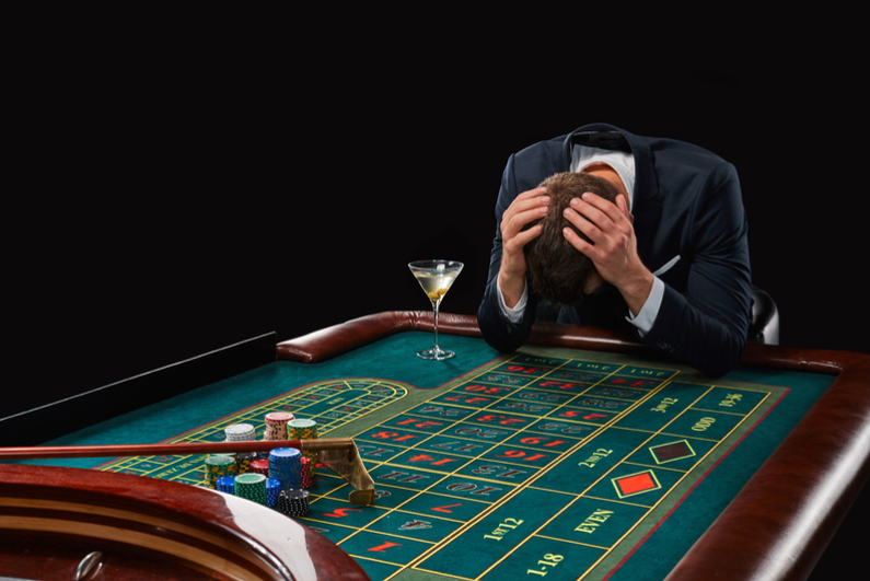 Depressed man at roulette table