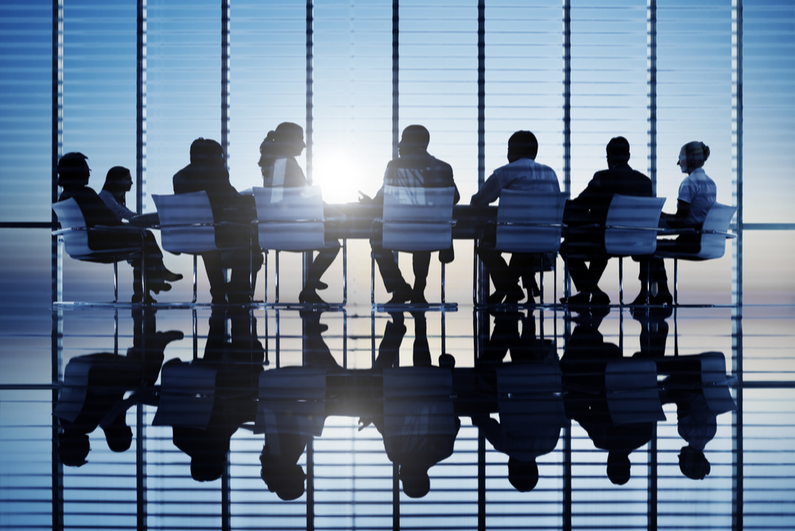 Silhouettes of people in conference room