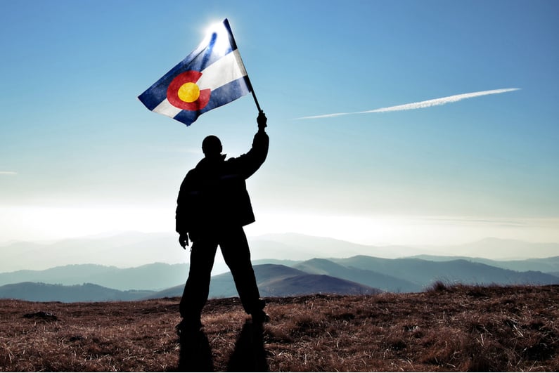 Man waving flag of Colorado