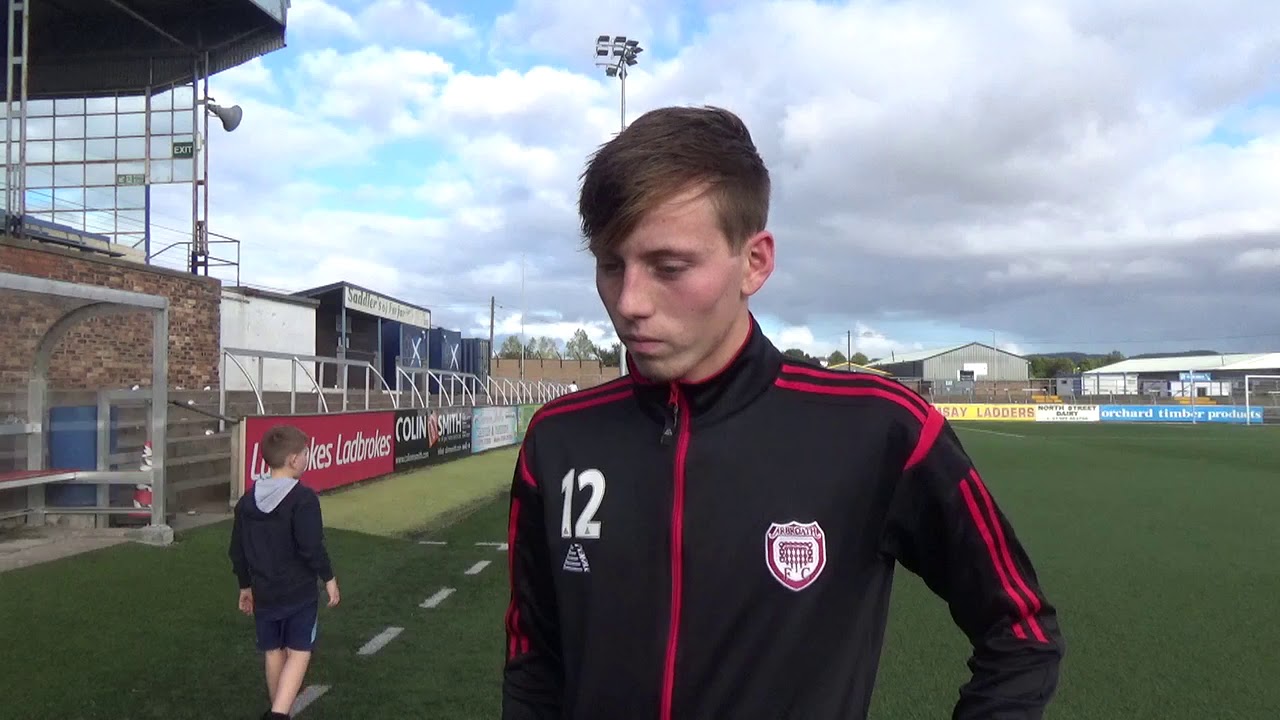 soccer player being interviewed on pitch