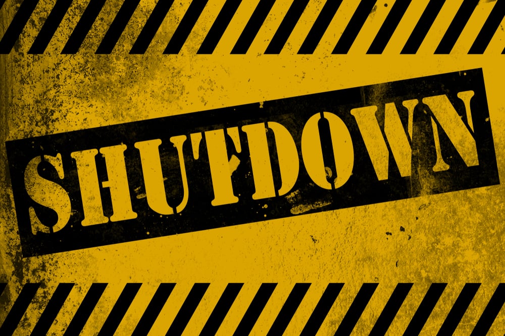 black and yellow shutdown sign