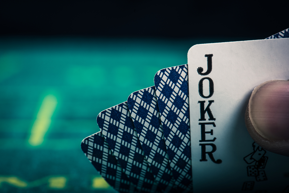 Poker player showing a joker as a hole card