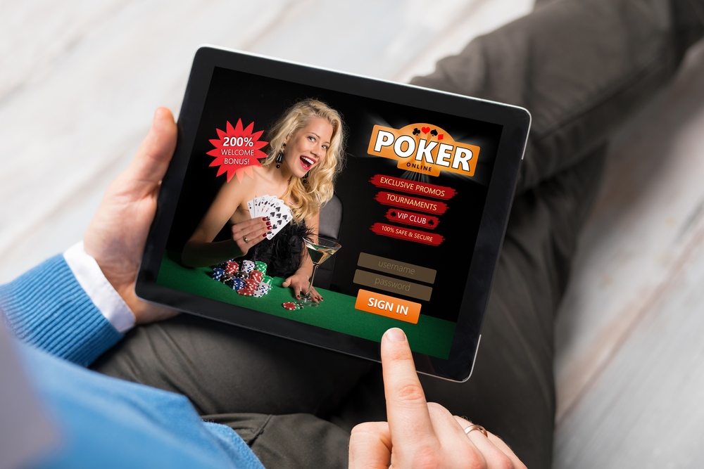 man playing online poker on tablet