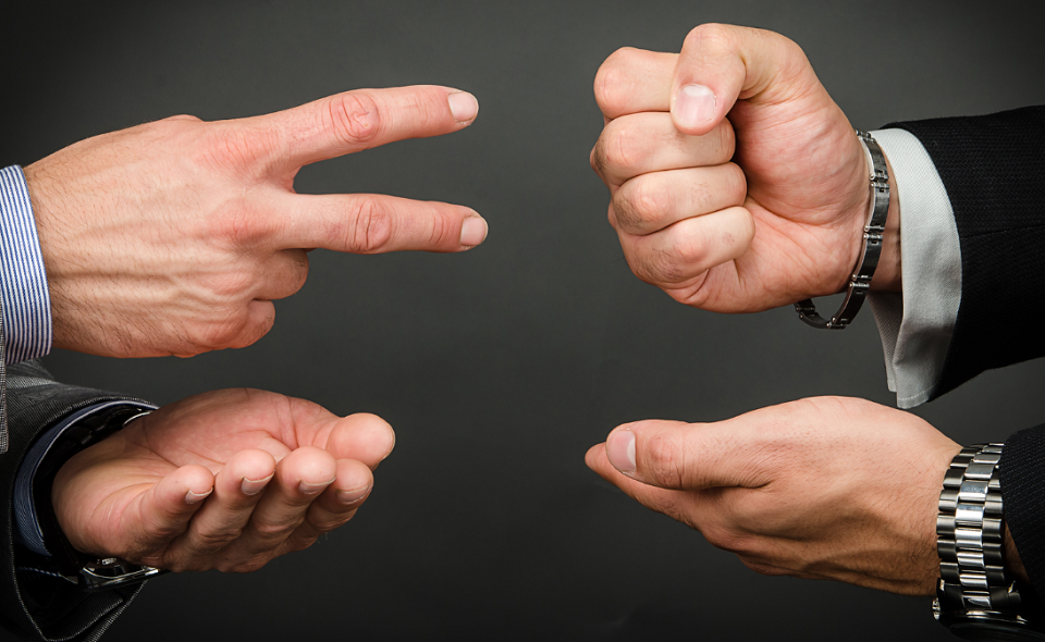 two men playing rock, paper, scissors