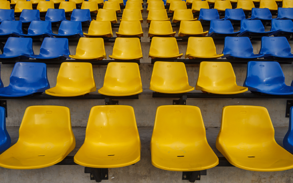 Empty blue and yellow stadium seats