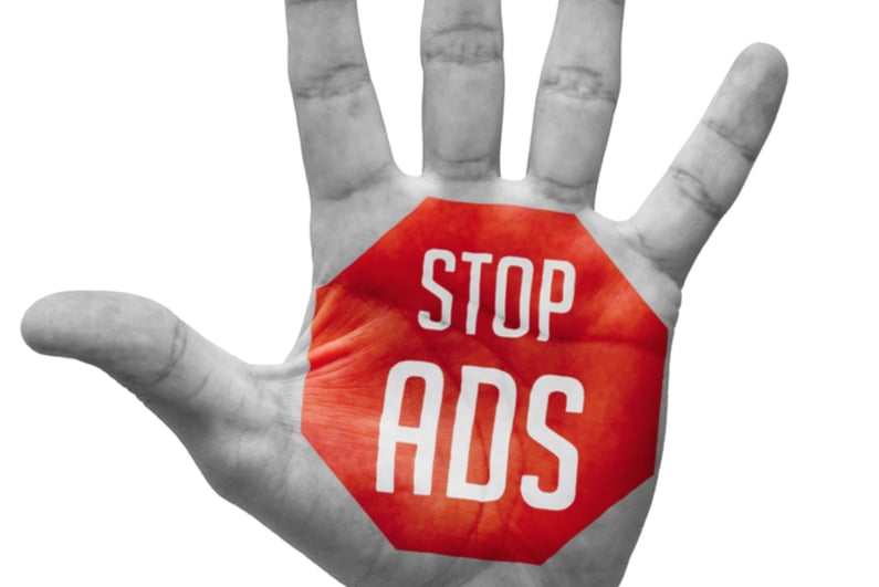 “stop ads” painted on a hand