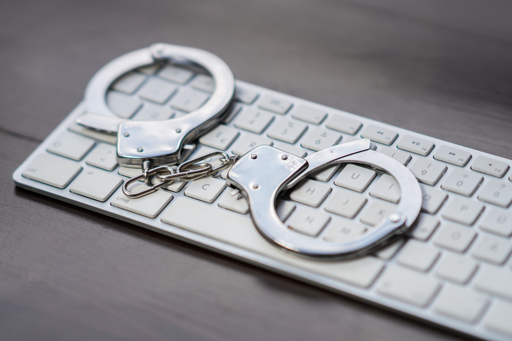 A computer keyboard with handcuffs