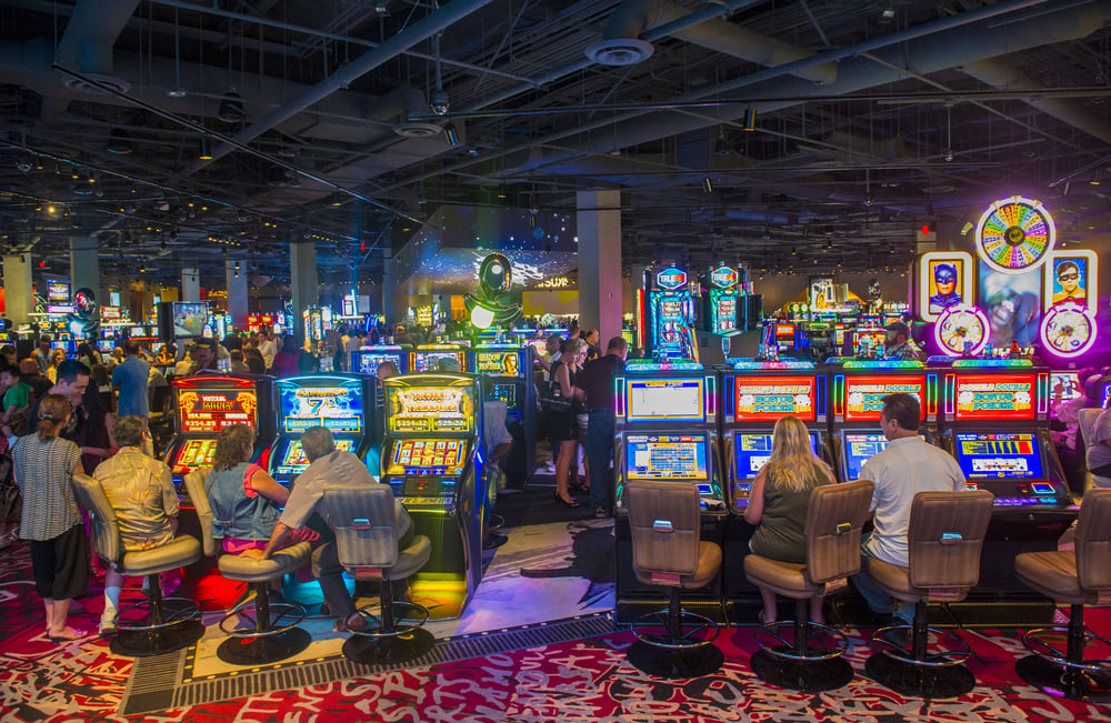 Gamblers playing slots in a busy casino