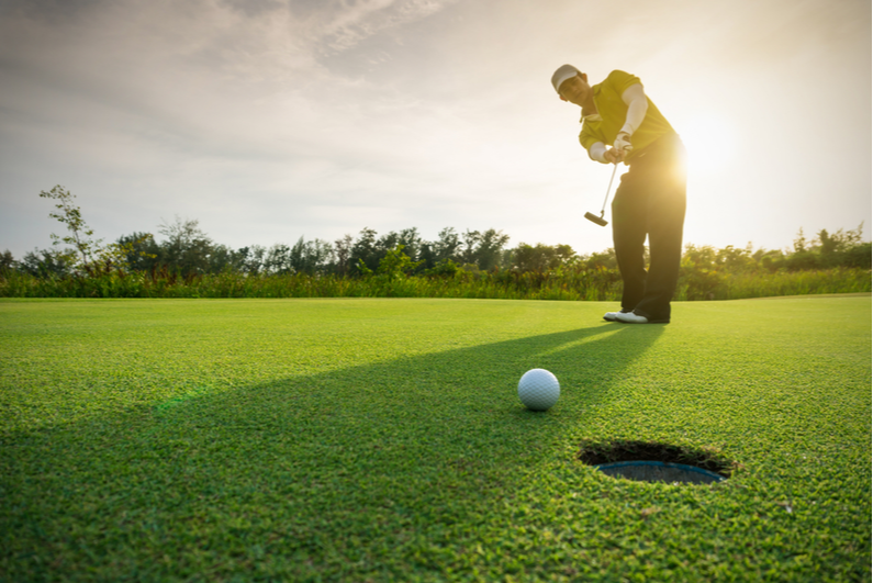 Golfer putting toward the camera